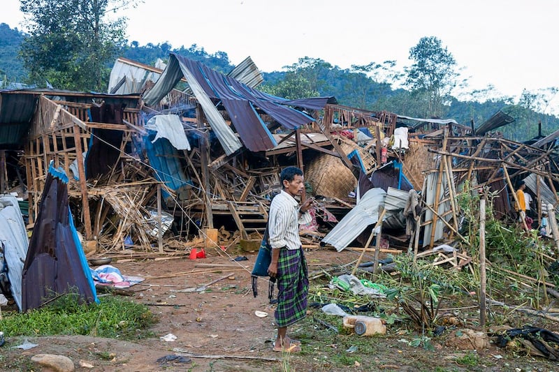 A man looks at homes destroyed after air and artillery strikes in Mung Lai Hkyet displacement camp, in Laiza, Myanmar, Oct. 10, 2023. (AP)