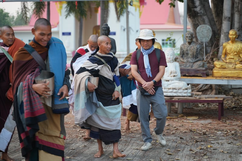 Vietnamese monk Thich Minh Tue walks during alms rounds in Nong Bua, Nakhon Sawan province, Thailand, Feb. 13, 2025.