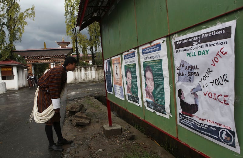 A Bhutanese man looks at posters of candidates on the eve of polling to the upper house National Council in Samdrup Jonkhar, Bhutan, April 22, 2013. Bhutan ended more than a century of absolute monarchy with its first parliamentary elections in 2008. (Anupam Nath/AP)