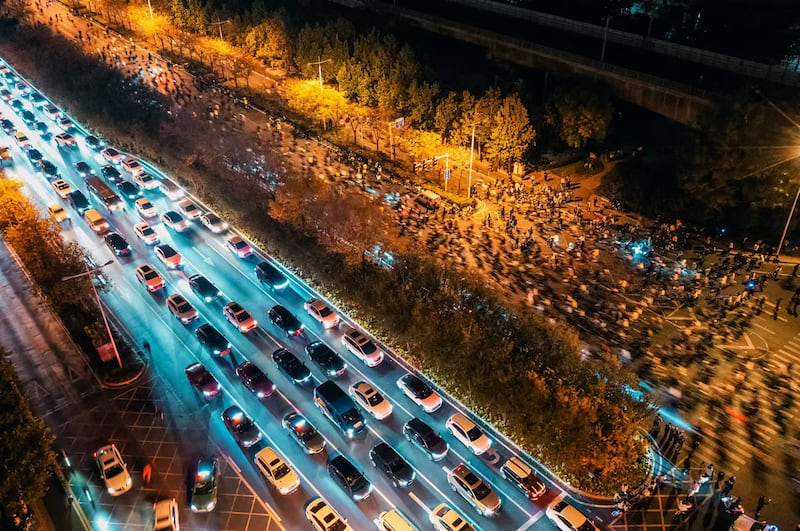Bike-riding college students pack the Zhengkai Road, top, in Zhengzhou, in China's Henan province, Nov. 9, 2024.