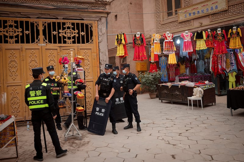 Police officers patrol in the old city in Kashgar in China’s Xinjiang region, May 3, 2021.