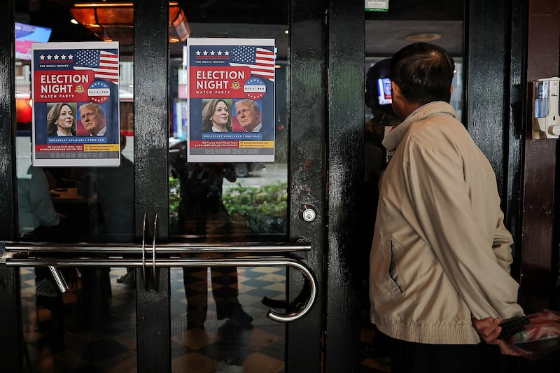 A person watches U.S. election coverage at a restaurant in Taipei, Nov. 6, 2024.