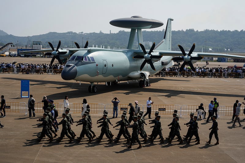 Chinese soldiers march past the Chinese KJ-500A AWACS airplane displayed at Airshow China 2024 at Zhuhai in China's Guangdong province on Nov. 12, 2024.