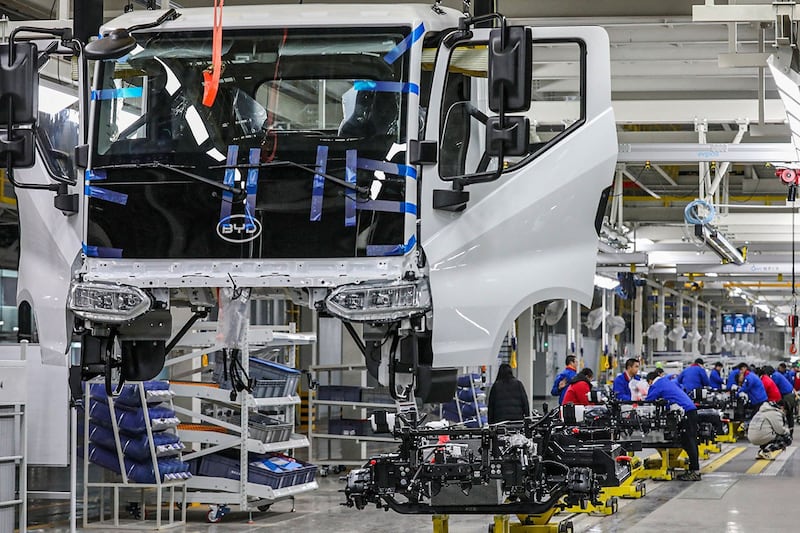 2024年2月21日,江苏省淮安市比亚迪工厂新能源汽车装配线上的员工。(法新社)