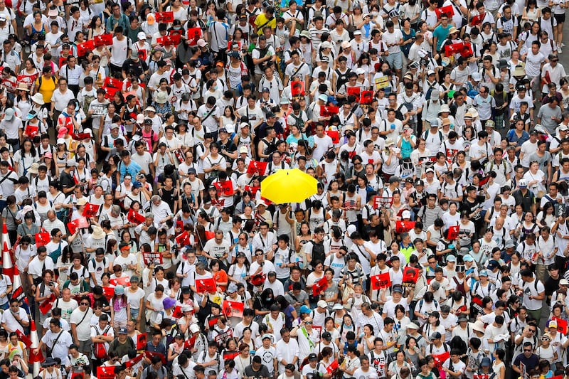 A protester holds up a yellow umbrella as he marches with thousands of others in a rally against the proposed amendments to extradition law in Hong Kong, June 9, 2019. (Kin Cheung/AP)